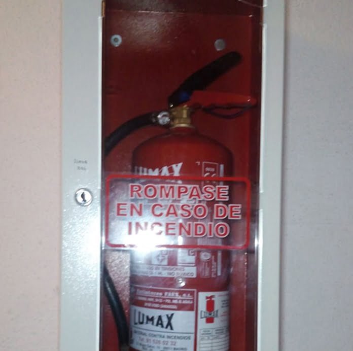 Extintor en armario con rótulo «Rómpase en caso de incendio»